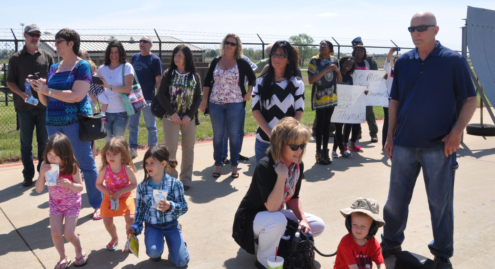 Family members of the 931st Air Refueling Group gather before greeting returning Airmen April 16, 2015, at McConnell Air Force Base, Kan. During the deployment, the 931 ARG flew and performed aircraft maintenance while assigned to the 379th Air Expeditionary Wing. (U.S. Air Force photo by Tech. Sgt. Abigail Klein)