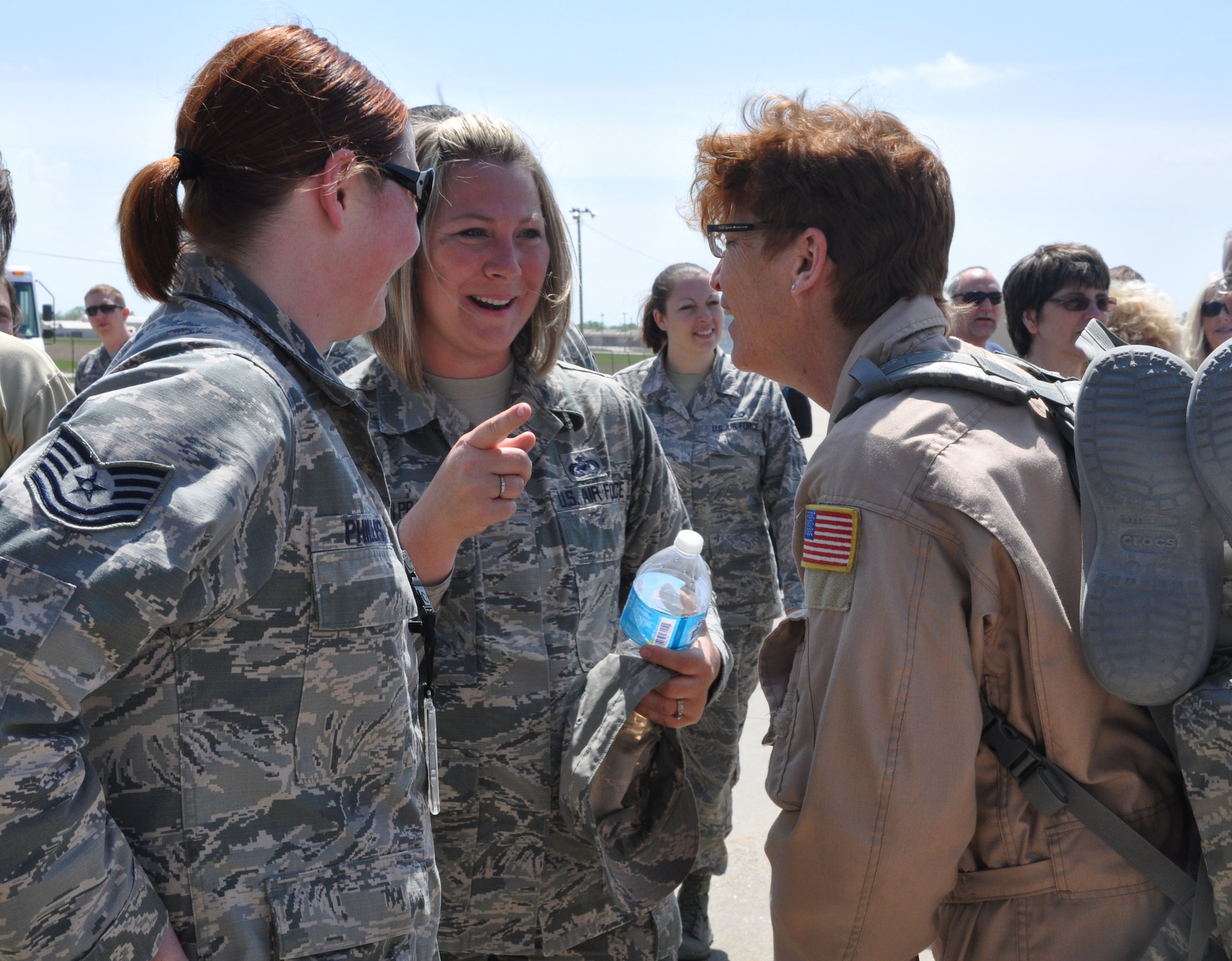 Tech. Sgts. Anne Phillips, 931st Maintenance Squadron jet mechanic, and Carrie Van Praag, 931st Air Refueling Group supply NCOIC, greet Chief Master Sgt. Kathy Lowman, 18th Air Refueling Squadron boom operator April 16, 2015, at McConnell Air Force Base, Kan. Lowman had just returned from a deployment to Southwest Asia, where she conducted refueling missions in support of the 379th Air Expeditionary Squadron. (U.S. Air Force photo by Tech. Sgt. Abigail Klein)
