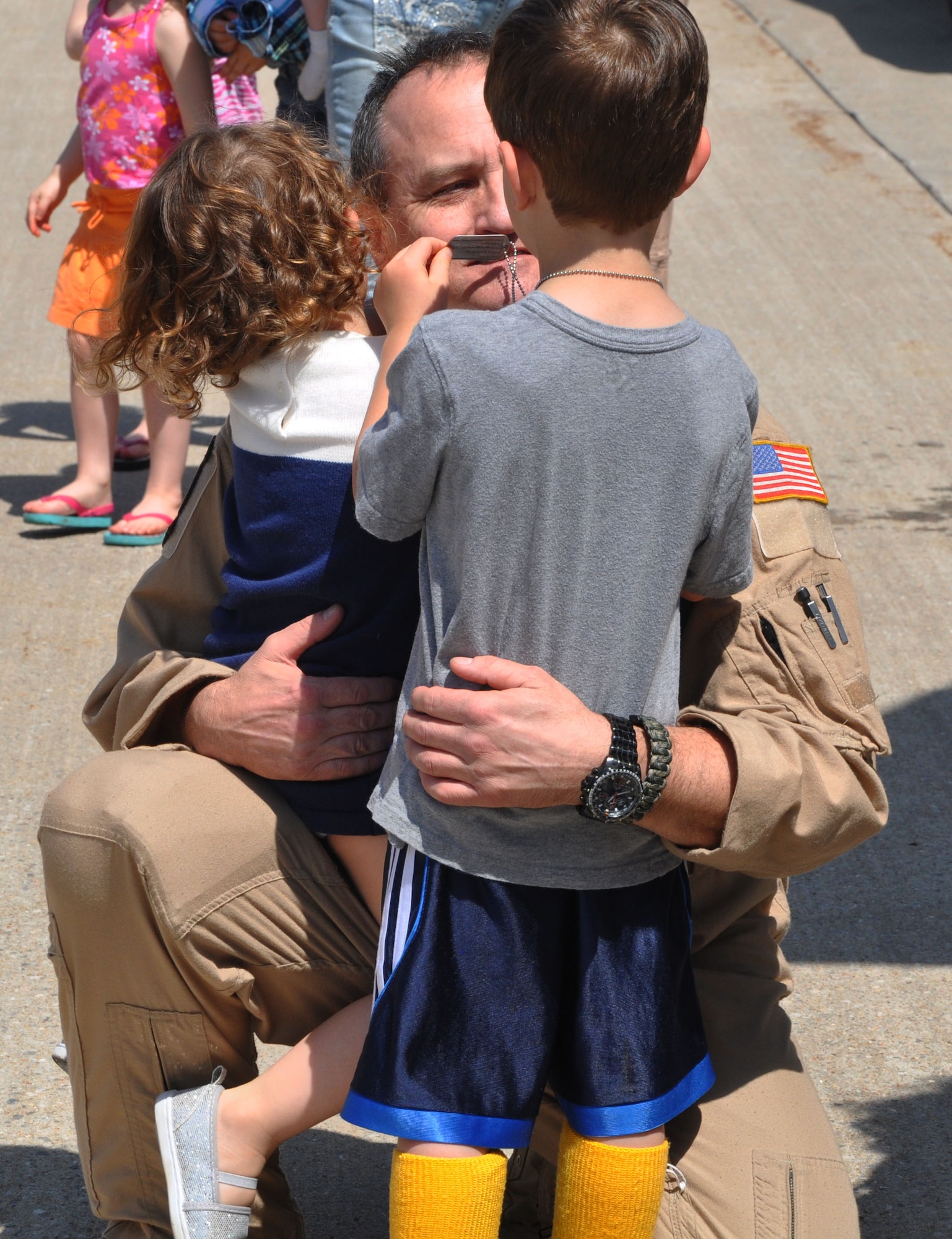 Senior Master Sgt. Brad Beyer, 18th Air Refueling Squadron boom operator, greets his children (left to right) Melody and Bryant April 16, 2015, at McConnell Air Force Base, Kan. Beyer had just returned from a deployment to Southwest Asia, where he conducted refueling missions in support of ongoing U.S. operations overseas. (U.S. Air Force photo by Tech. Sgt. Abigail Klein)