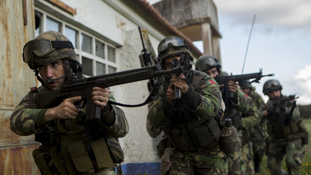 Portuguese Marines, Fuzileiros, move to clear a room during an assault training exercise near Lisbon, Portugal, April 9, 2015. U.S. Marines with Special-Purpose Marine Air-Ground Task Force Crisis Response-Africa and Fuzileiros simulated breaching a compound side-by-side demonstrating the interoperability of the two NATO forces for potential future operations. (U.S. Marine Corps photograph by Lance Cpl. Christopher Mendoza/Released)