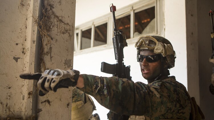 U.S. Marine Corps Sgt. Nicholas Perrorazio, a squad leader with Special-Purpose Marine Air-Ground Task Force Crisis Response Africa, directs his squad to clear a room during an assault training exercise near Lisbon, Portugal, April 10, 2015. Marines stationed out of Moron Air Base, Spain, traveled to Portugal to utilize a variety of different ranges and training exercises alongside with the Portuguese Marines. After a week of training together, Marines and Fuzileiros were more familiar with each other's tactics and operating procedures. (U.S. Marine Corps photograph by Lance Cpl. Christopher Mendoza/Released)