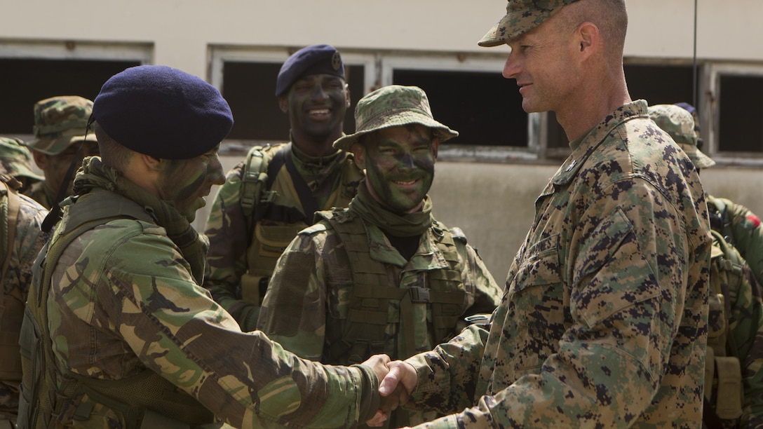 U.S. Marine Corps Col. Thomas Savage, right, commanding officer, Special-Purpose Marine Air-Ground Task Force Crisis Response-Africa, shakes hands with a Portuguese Marine after an assault training exercise near Lisbon, Portugal, April 10, 2015. Marines stationed out of Moron Air Base, Spain, traveled to Portugal to utilize a variety of different ranges and training exercises alongside with the Portuguese Marines. After a week of training together, Marines and Fuzileiros were more familiar with each other's tactics and operating procedures. (U.S. Marine Corps photograph by Lance Cpl. Christopher Mendoza/Released)