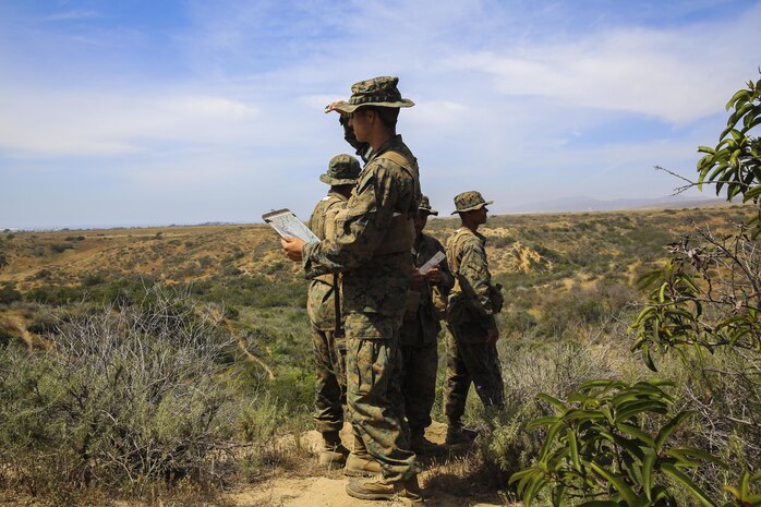 Recruits of Golf Company, 2nd Recruit Training Battalion, work together to attempt to find their next geographical point during the land navigation course at Edson Range, Marine Corps Base Camp Pendleton, Calif., March 31. Each navigation point is marked with a numbered ammunition can, and each pair of recruits was given a different route to follow. Recruits are given five points to find along the course, and while they had already plotted where each point was, they have to use what they have learned to identify the correct direction. They were encouraged to use terrain features and navigation tools they were given to help them find their checkpoints. Today, all male recruits recruited from recruiting stations west of the Mississippi are trained at MCRD San Diego. The depot is responsible for training more than 16,000 recruits annually. Golf Company is scheduled to graduate May 8.