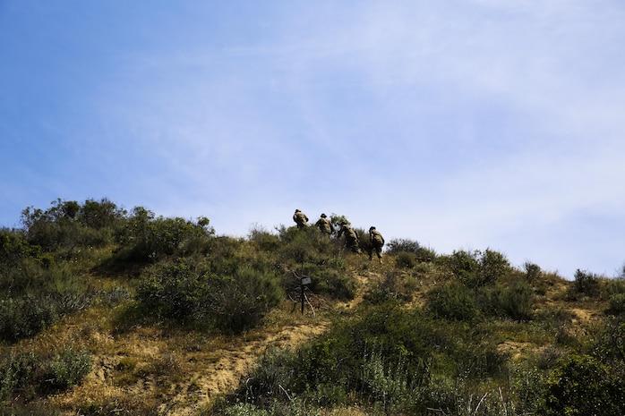 Recruits of Golf Company, 2nd Recruit Training Battalion, hike to the top of a mountain in search of their next geographical point during the land navigation course at Edson Range, Marine Corps Base Camp Pendleton, Calif., March 31. Land navigation is designed to give recruits an introduction to map reading, pace counts, shooting an azimuth and to get them comfortable with using a map and a compass. Recruits will be able to utilize their land navigation skills again after recruit training while at the School of Infantry. Today, all male recruits recruited from recruiting stations west of the Mississippi are trained at MCRD San Diego. The depot is responsible for training more than 16,000 recruits annually. Golf Company is scheduled to graduate May 8.