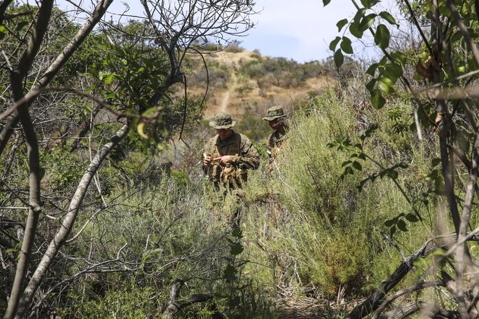 Recruits of Golf Company, 2nd Recruit Training Battalion, battle through the rough terrain in search of their next geographical point during the land navigation course at Edson Range, Marine Corps Base Camp Pendleton, Calif., March 31. During Field Week, or week seven of recruit training, recruits learned the basic fundamentals of combat, with topics ranging from combat formations to land navigation. The course is buried deep in the midst Camp Pendleton, covered with cacti, bushes and various wildlife. Recruits have four hours to find five check points. If they are incorrect in any point, they must retrace their steps and find their errors. Today, all male recruits recruited from recruiting stations west of the Mississippi are trained at MCRD San Diego. The depot is responsible for training more than 16,000 recruits annually. Golf Company is scheduled to graduate May 8.

