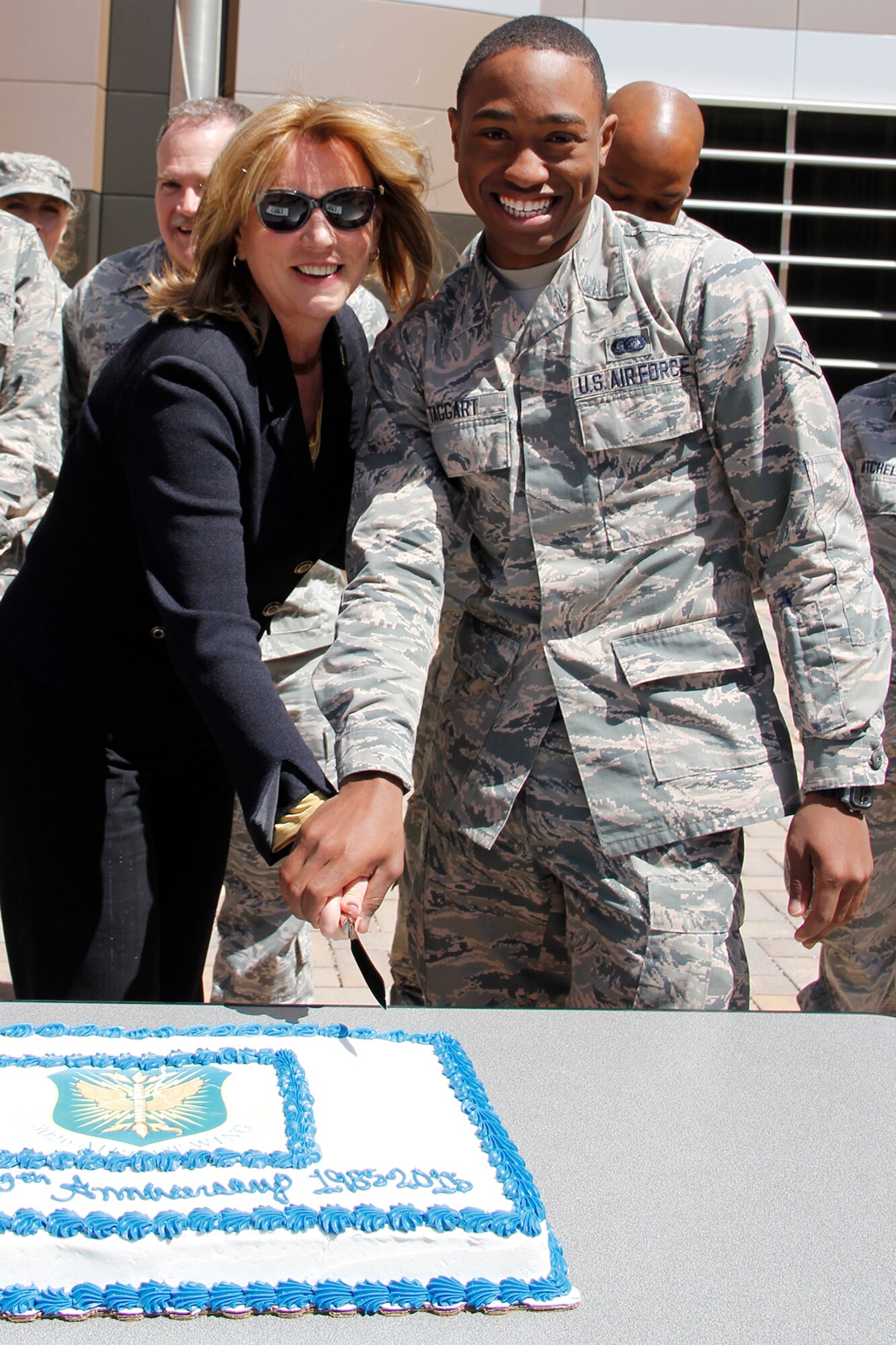 Secretary of the Air Force Deborah Lee James cuts the 302nd Airlift Wing 30th Anniversary cake with the Reserve wing’s most junior Airman present, Airman Kion Taggart, April 15, 2015. During the Secretary’s visit to the Reserve wing she received both the 302nd AW mission and Modular Airborne Fire Fighting System briefings and met with Airmen in several of the wing’s units. Taggart is a commander support staff technician with the 302nd Maintenance Group. The 302nd AW is celebrating 30 years since the April 1, 1985 reactivation as an airlift wing based at Peterson AFB. (U.S. Air Force photo/Staff Sgt. Nathan Federico)