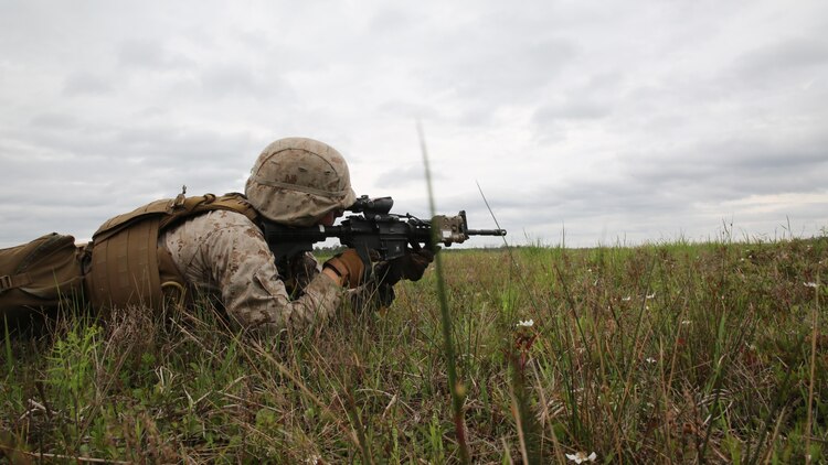 Lance Cpl. Taylor Lara, a rifleman with 2nd Light Armored Reconnaissance Battalion, sights in on a target during a live-fire platoon attack exercise at Marine Corps Base Camp Lejeune, North Carolina, April 15, 2015. The exercise tested the unit’s operational skills while acting in an attack and support capacity with on-foot assaults and suppressive fire from their vehicles or machine guns.