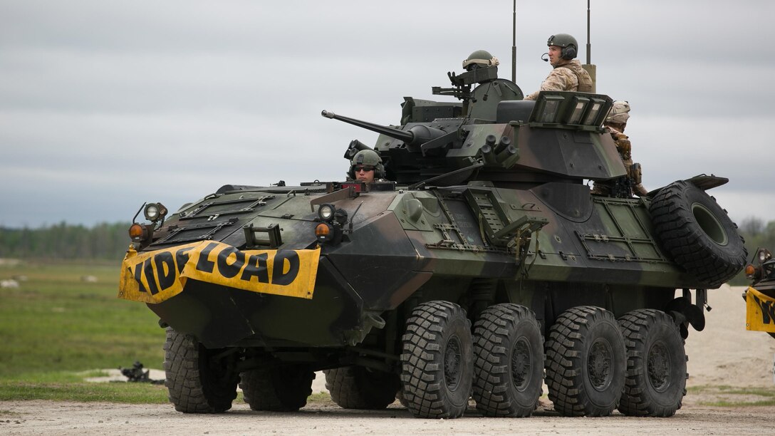 Marines with 2nd Light Armored Reconnaissance Battalion await orders to drive troops to a drop-off zone prior to a simulated dismounted attack during a live-fire platoon attack exercise on Marine Corps Base Camp Lejeune, North Carolina, April 15, 2015. The mission of 2nd LAR Bn. is to provide company-sized reconnaissance units to support military operations of the United States and its allies.