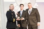 U.S. Army Gen. Frank J. Grass, National Guard Bureau Chief, and Operation Homefront president Tim Farrell present National Guard Child of the Year nominee Zachary Alan Parsons with a trophy during the 2015 Military Child of the Year Awards Gala, in Arlington, Virginia, April 16, 2015. The awards gala is held to recognize outstanding military children - one nominated for each of the service branches.