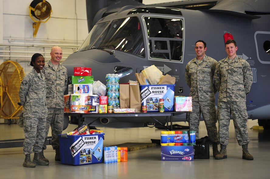 Airmen from the 801st Special Operations Aircraft Maintenance Squadron stand by donations going to the Fisher House of Emerald Coast at Hurlburt Field, Fla., Apr. 15, 2015. (U.S. photo by Senior Airman Meagan Schutter)