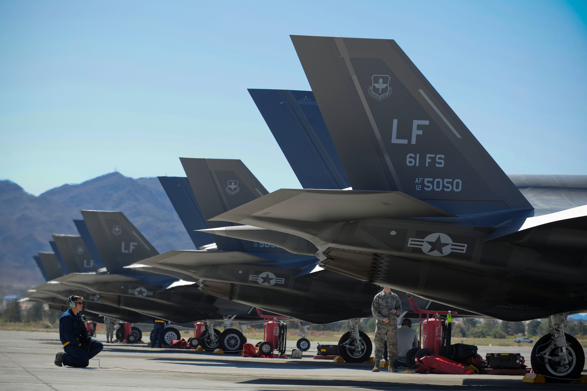 Staff Sgt. Michael Ensminger, 61st Aircraft Maintenance Unit Staff F-35 dedicated crew chief inspects one of Luke Air Force Base, Arizona F-35s sent to Nellis Air Force Base, Nevada for the training deployment April 15, 2015. (U.S. Air Force photo by Staff Sgt. Darlene Seltmann)