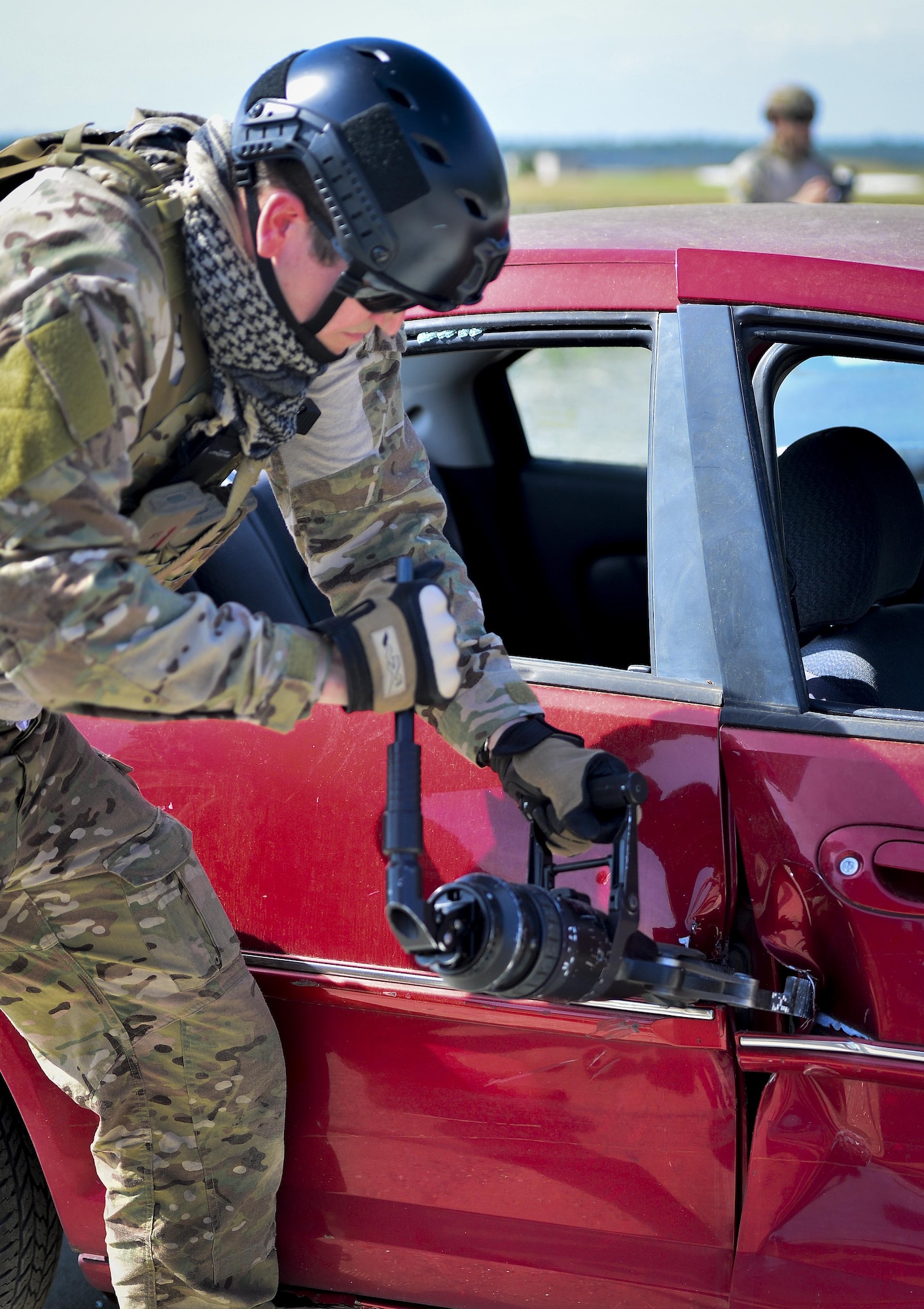 A Pararescueman from the Special Tactics Training Squadron uses a spreader to pry open a car door during extrication training at Hurlburt Field, Fla., April 8, 2014. The Special Tactics pararescuemen were training to retrieve injured or trapped personnel from vehicles and aircraft. (U.S. Air Force photo/Airman 1st Class Jeff Parkinson)