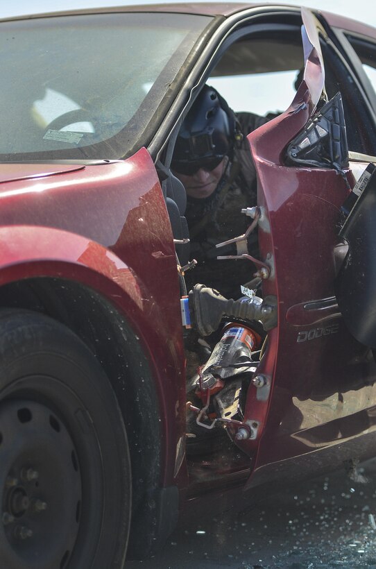 A Pararescueman from the Special Tactics Training Squadron uses a spreader during extrication training at Hurlburt Field, Fla., April 8, 2014. The Special Tactics pararescuemen were training to retrieve injured or trapped personnel from vehicles and aircraft. (U.S. Air Force photo/Airman 1st Class Jeff Parkinson)