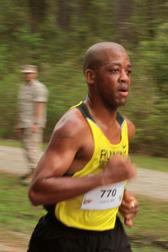 Master Sgt. Vincent C.Savage nears the finish line during the Marine Corps Air Station Cherry Point and 2nd Marine Aircraft Wing Sexual Assault Awareness Month Commemorative 5K along Rifle Range Road, April 17, 2015. 
The event drew nearly 1,000 Marines, Sailors and Department of Defense employees who ran the 3.1 mile course to show solidarity with sexual assault survivors and a shared commitment to eradicating sexual violence across the Marine Corps.  
Savage is the logistics chief for Headquarters and Headquarters Squadron. 