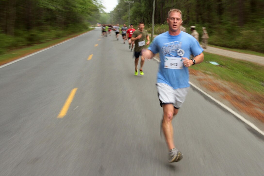Participants in the Marine Corps Air Station Cherry Point and 2nd Marine Aircraft Wing Sexual Assault Awareness Month Commemorative 5K near the finish line along Rifle Range Road, April 17, 2015. 
The event drew nearly 1,000 Marines, Sailors and Department of Defense employees who ran the 3.1 mile course to show solidarity with sexual assault survivors and a shared commitment to eradicating sexual violence across the Marine Corps.  