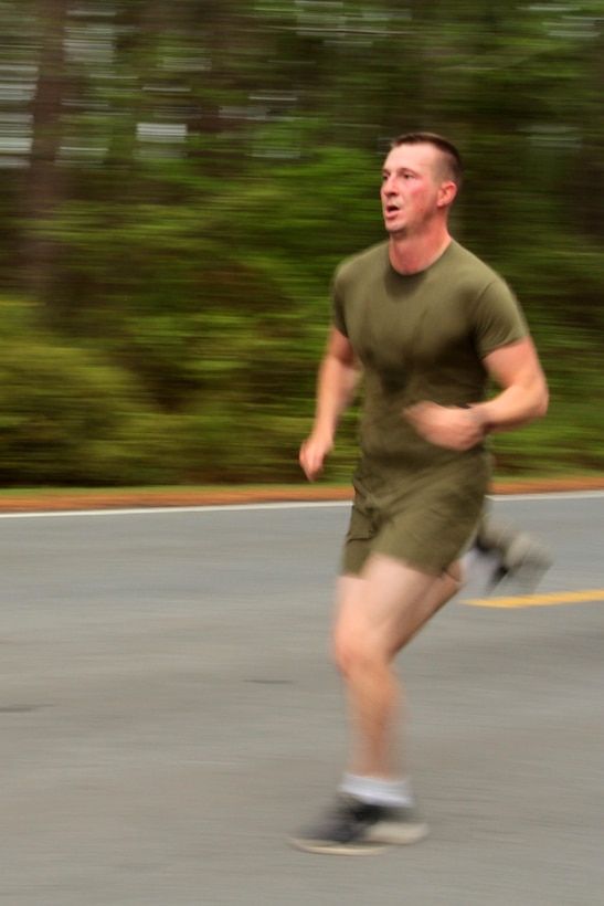 A participant in the Marine Corps Air Station Cherry Point and 2nd Marine Aircraft Wing Sexual Assault Awareness Month Commemorative 5K nears the finish line along Rifle Range Road, April 17, 2015. 
The event drew nearly 1,000 Marines, Sailors and Department of Defense employees who ran the 3.1 mile course to show solidarity with sexual assault survivors and a shared commitment to eradicating sexual violence across the Marine Corps.  