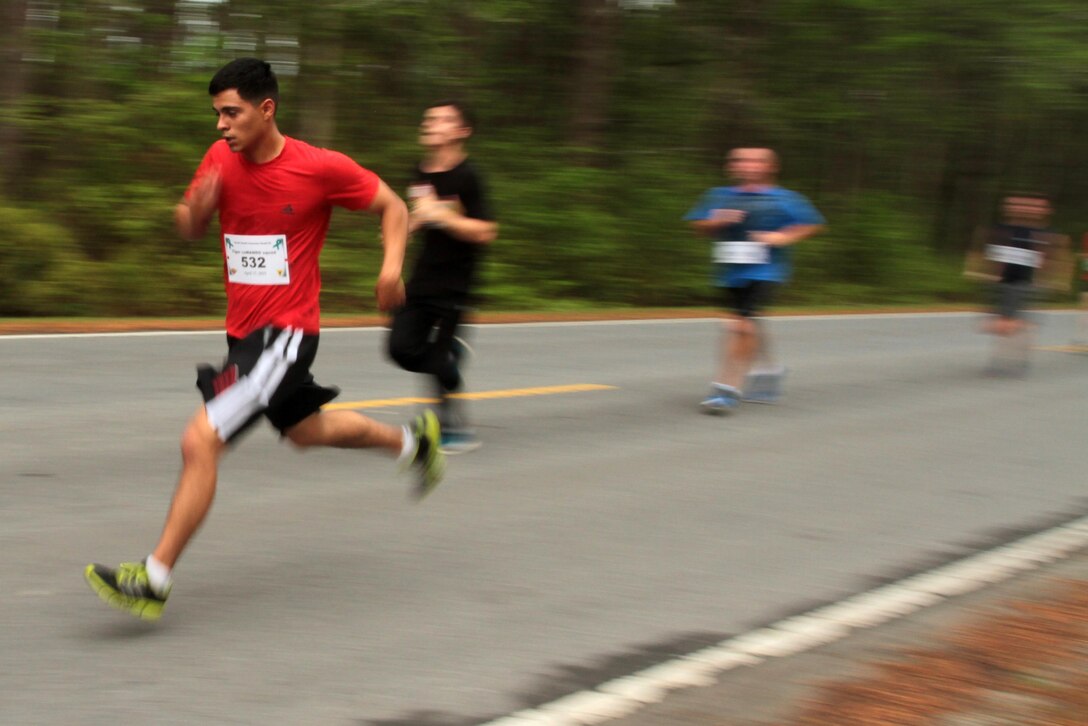 Participants in the Marine Corps Air Station Cherry Point and 2nd Marine Aircraft Wing Sexual Assault Awareness Month Commemorative 5K near the finish line along Rifle Range Road, April 17, 2015. 
The event drew nearly 1,000 Marines, Sailors and Department of Defense employees who ran the 3.1 mile course to show solidarity with sexual assault survivors and a shared commitment to eradicating sexual violence across the Marine Corps.  
