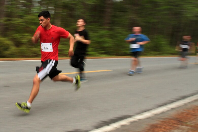 Participants in the Marine Corps Air Station Cherry Point and 2nd Marine Aircraft Wing Sexual Assault Awareness Month Commemorative 5K near the finish line along Rifle Range Road, April 17, 2015. 
The event drew nearly 1,000 Marines, Sailors and Department of Defense employees who ran the 3.1 mile course to show solidarity with sexual assault survivors and a shared commitment to eradicating sexual violence across the Marine Corps.  
