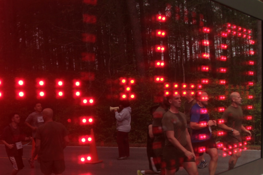 Participants in the Marine Corps Air Station Cherry Point and 2nd Marine Aircraft Wing Sexual Assault Awareness Month Commemorative 5K near the finish line along Rifle Range Road, April 17, 2015. 
The event drew nearly 1,000 Marines, Sailors and Department of Defense employees who ran the 3.1 mile course to show solidarity with sexual assault survivors and a shared commitment to eradicating sexual violence across the Marine Corps.  