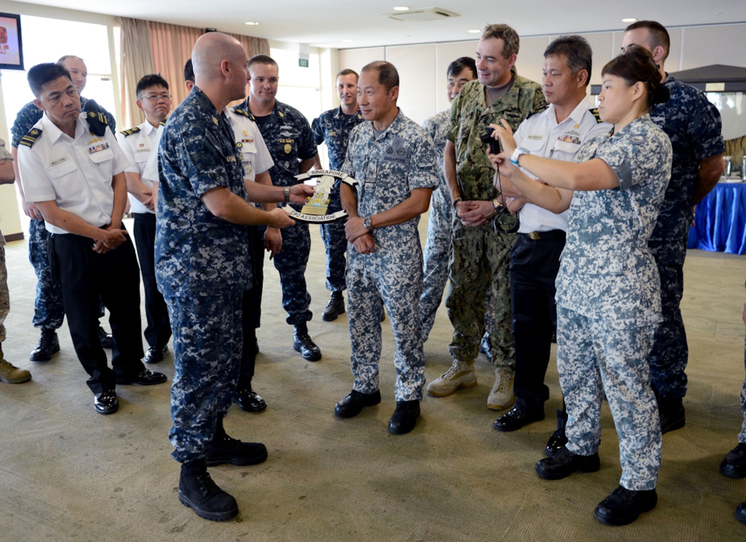 SINGAPORE (Apr. 16, 2015) - Commander, Task Force 73 Command Master Chief Richard O'Rawe presents Republic of Singapore Master Chief Petty Officer of the Navy (MCPON) Military Expert (ME) 6 Phui Peng Sim a plaque from the U.S. Navy Chief Petty Officer's Association of Singapore.  The U.S. and Republic of Singapore navies held a Senior Enlisted Leadership Exchange. 