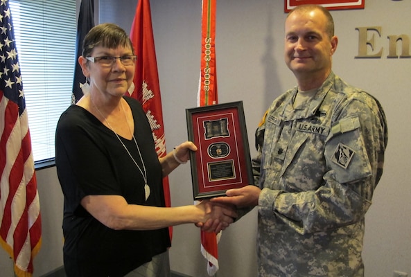 Huntsville Center's deputy commander, Lt. Col. Kendall Bergmann presented Nelson a Huntsville Center plaque during a reception at the organization April 17.
