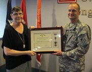 Huntsville Center's deputy commander, Lt. Col. Kendall Bergmann presented Nelson the Commander's Award for Civilian Service during a reception at the organization April 17.