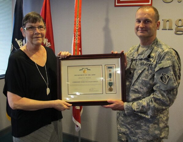 Huntsville Center's deputy commander, Lt. Col. Kendall Bergmann presented Nelson the Commander's Award for Civilian Service during a reception at the organization April 17.