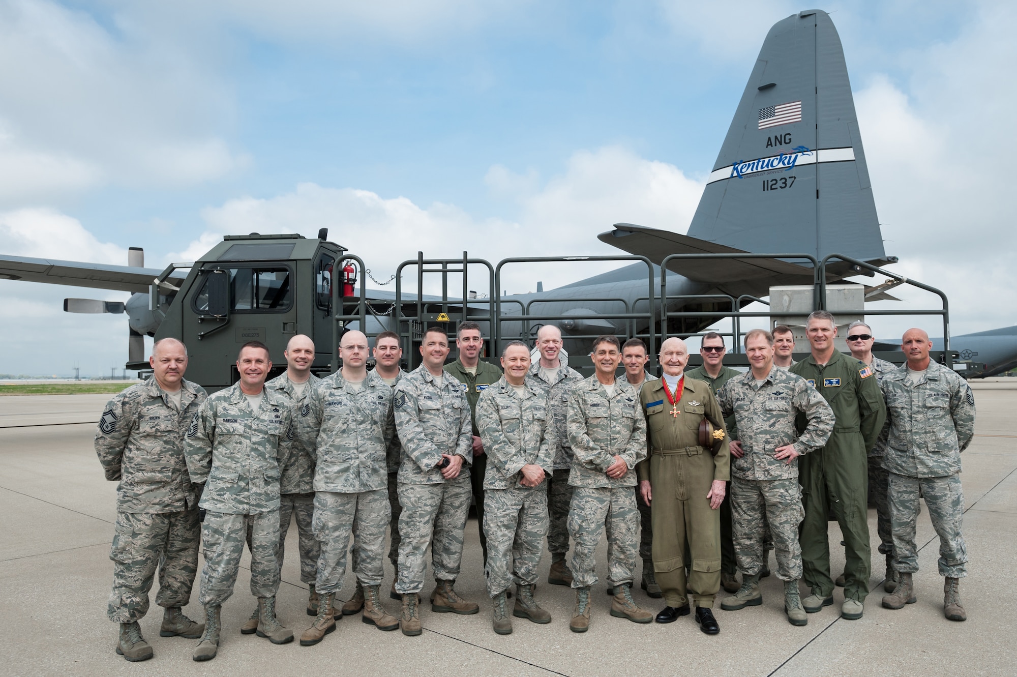 Col. Gail Halvorsen, a former U.S. Army Air Corps pilot who originated the idea of airdropping candy to German children during the 1948-49 Berlin Airlift, visits the Kentucky Air National Guard Base in Louisville, Ky., April 17, 2015. Halvorsen, who is known as the Berlin Candy Bomber, will be the guest of honor during the 2015 Thunder Over Louisville air show April 18. The Airmen are standing in front of a Halverson Loader, named for the colonel, that can rapidly load up to 25,000 pounds of cargo onto airlift aircraft. (U.S. Air National Guard photo by Maj. Dale Greer)