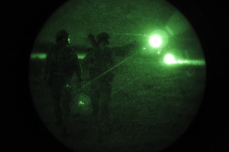 U.S. Air Force Pararescuemen assigned to the 48th Rescue Squadron walk away from a HH-60G Pavehawk after loading simulated patients for extraction during a mass casualty exercise at Davis-Monthan Air Force Base, Ariz., April 14, 2015. During the exercise, the Airmen were evaluated on how they respond to several mass casualty situations to include their ability calling in air support for patient extrication. (U.S. Air Force photo by Senior Airman Betty R. Chevalier)