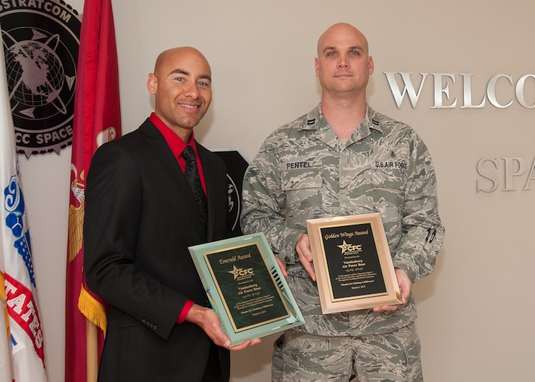 Jason Welsh, Santa Barbara District Office Social Security Administration district manager, presents Capt. Jonathan Pentel, 30th Medical Group practice manager, Team Vandenberg’s Combined Federal Campaign Emerald and Golden Wings awards, April 15, 2015, Vandenberg Air Force Base, Calif. The unit was recognized for their generous support to local, national and global communities. (U.S. Air Force photo by Michael Peterson/Released)