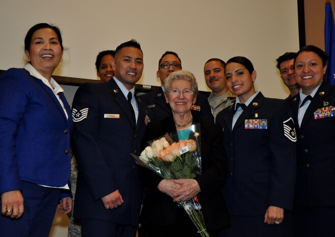Members of the Holocaust Days of Remembrance breakfast committee pose for a picture with Holocaust survivor Liz Igra at Beale Air Force Base, Calif., April 17, 2015. Igra and her mother escaped Nazi persecution by assuming false identities. (U.S. Air Force photo by Airman 1st Class Taylor A. Workman/Released)