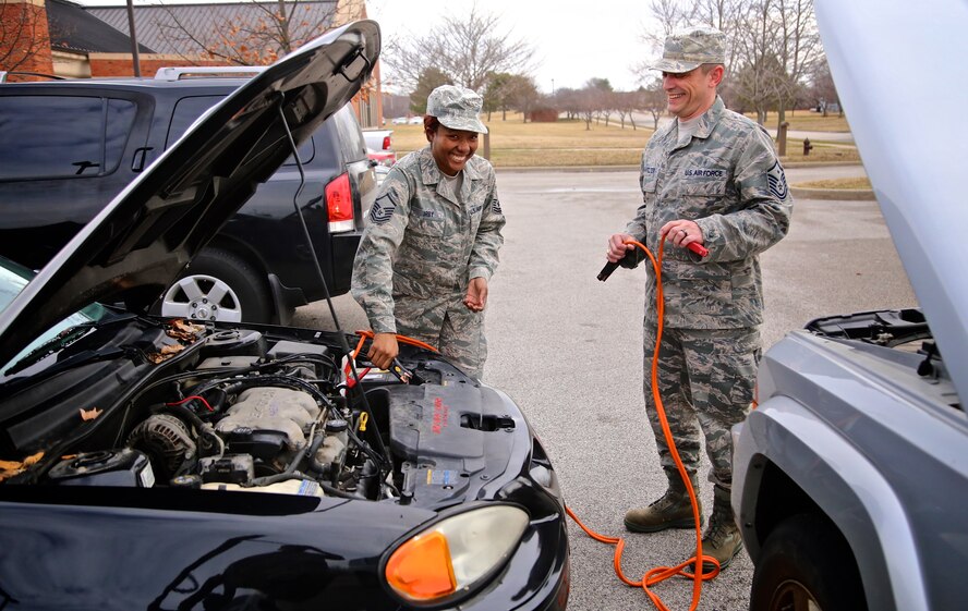 Master Sgt. John Linafelter, 1st Sgt. with 73rd Airlift Squadron offers assistance to Master Sgt. Candace Irby, with the 932nd Airlift Wing Aeromedical Staging Squadron, March 14, 2015 Scott Air Force Base, Ill.  It was a quick battery jump and Irby was on her way.    