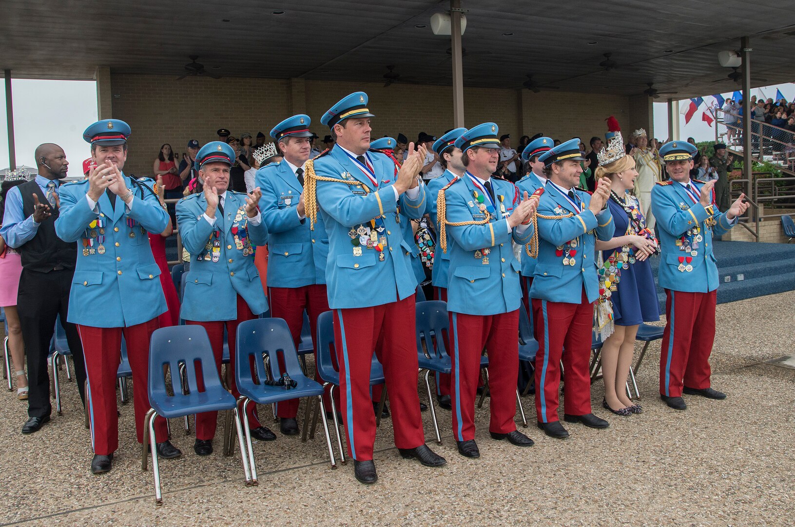 Members of the Fiesta Executive Committee, who represent various civic organizations throughout the city of San Antonio, observe a Basic Military Training graduation parade April 17, 2015, at Joint Base San Antonio-Lackland, Texas. The full-scale Basic Military Training Graduation Parade is the only military graduation incorporated into Fiesta and features more than 1,000 distinctive military members and the 323rd Training Squadron Drum and Bugle Corps. Fiesta San Antonio, the city's 11-day cascarón-filled celebration, began as a one-time parade in 1891 to honor the memory of the heroes of the Alamo and the Battle of San Jacinto. Over the past century, Fiesta has grown into a celebration of San Antonio's rich and diverse cultures. Military representative from throughout San Antonio participate in receptions, parades, pilgrimages and memorials. (U.S. Air Force photo by Johnny Saldivar/released)
