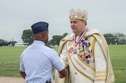 Col. Trent Edwards, 37th Training Wing commander, presents a Fiesta Medal to 2015 Fiesta Royalty, Jon Gary Herrera, El Rey Feo the 67th, April 17, 2015, at Joint Base San Antonio-Lackland, Texas. The full-scale Basic Military Training Graduation Parade is the only military graduation incorporated into Fiesta and features more than 1,000 distinctive military members and the 323rd Training Squadron Drum and Bugle Corps. Fiesta San Antonio, the city's 11-day cascarón-filled celebration, began as a one-time parade in 1891 to honor the memory of the heroes of the Alamo and the Battle of San Jacinto. Over the past century, Fiesta has grown into a celebration of San Antonio's rich and diverse cultures. Military representative from throughout San Antonio participate in receptions, parades, pilgrimages and memorials. (U.S. Air Force photo by Johnny Saldivar/released)

