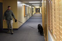 Staff Sgt. David Nierzwicki, 341st Security Forces Squadron military working dog handler, and his MWD Zsabi, check for any possible threats during a training exercise April 16, 2015, at Malmstrom Air Force Base, Mont. Training missions provide different scenarios not just for the dog, but for the handler as well. (U.S. Air Force photo/Chris Willis)