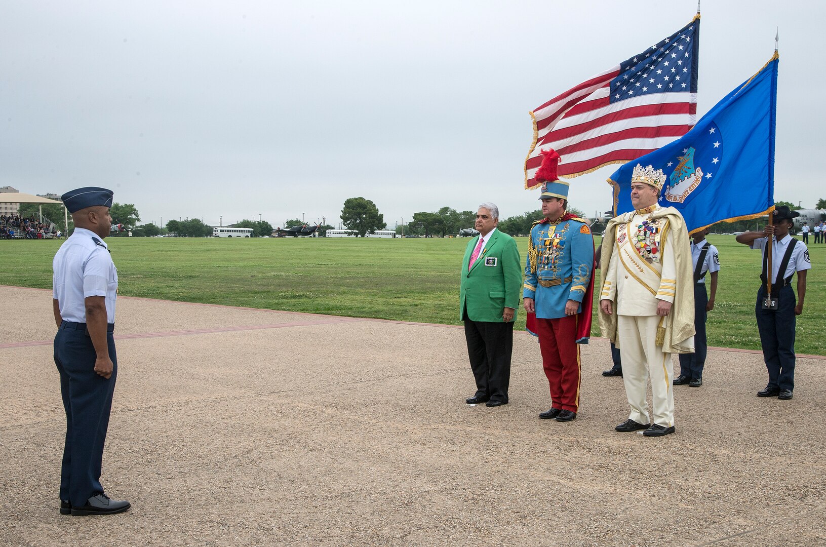 Col. Trent Edwards, 37th Training Wing commander, prepares to present Fiesta Medals to 2015 Fiesta Royalty, from left, Fernando Reyes, Fiesta San Antonio Commission president, Mark M. Johnson Jr., Texas Cavaliers King Antonio the 93rd, and Jon Gary Herrera, El Rey Feo the 67th, April 17, 2015, at Joint Base San Antonio-Lackland, Texas. The full-scale Basic Military Training Graduation Parade is the only military graduation incorporated into Fiesta and features more than 1,000 distinctive military members and the 323rd Training Squadron Drum and Bugle Corps. Fiesta San Antonio, the city's 11-day cascarón-filled celebration, began as a one-time parade in 1891 to honor the memory of the heroes of the Alamo and the Battle of San Jacinto. Over the past century, Fiesta has grown into a celebration of San Antonio's rich and diverse cultures. Military representative from throughout San Antonio participate in receptions, parades, pilgrimages and memorials. (U.S. Air Force photo by Johnny Saldivar)