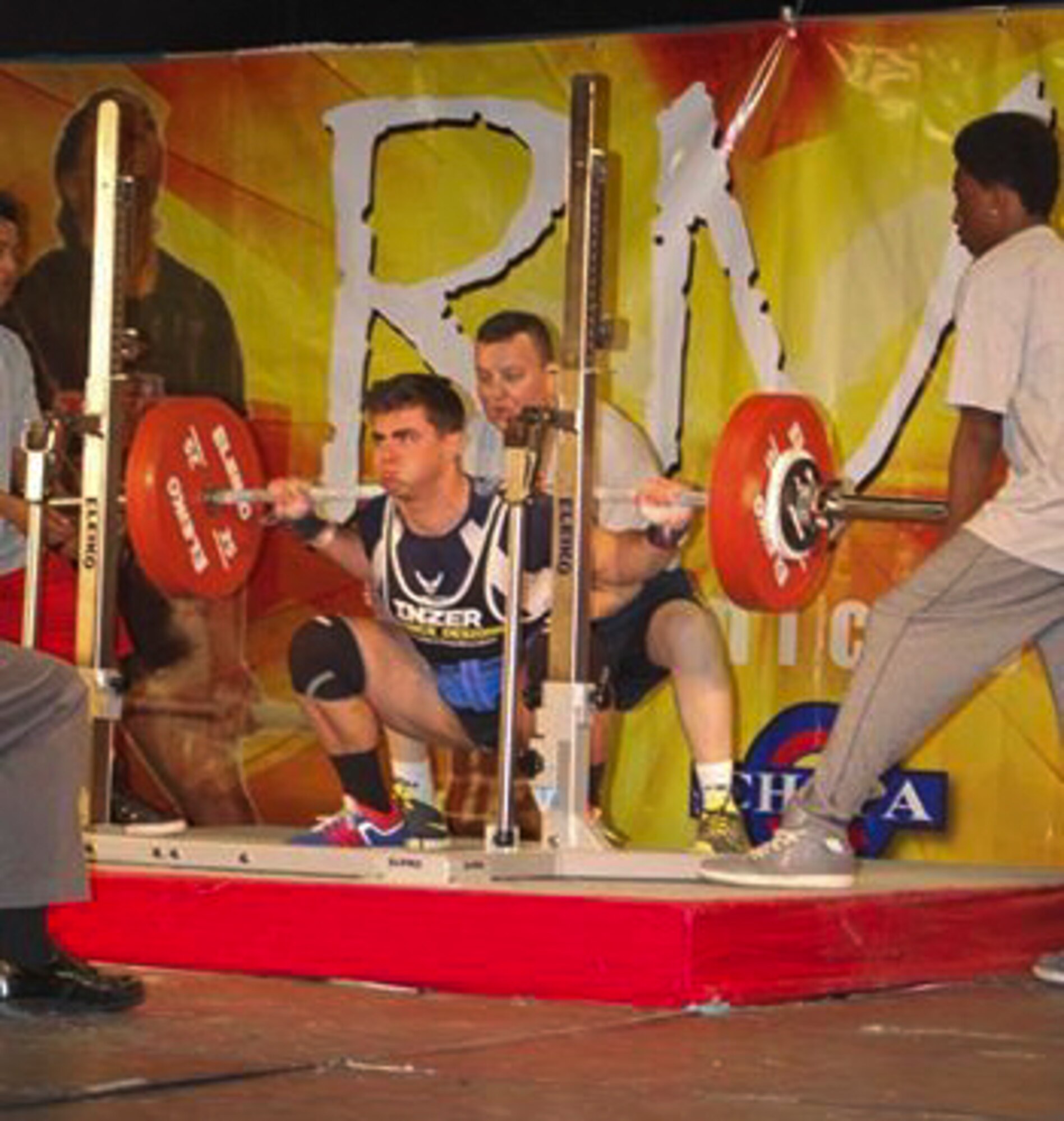 Senior Airman Jacob Horton, 460th Contracting Flight, pushes out an exercise during his win at his first ever powerlifting competition in February 2015 in Colorado. He began powerlifting while on deployment and has been competing successfully since then. (Courtesy Photo)