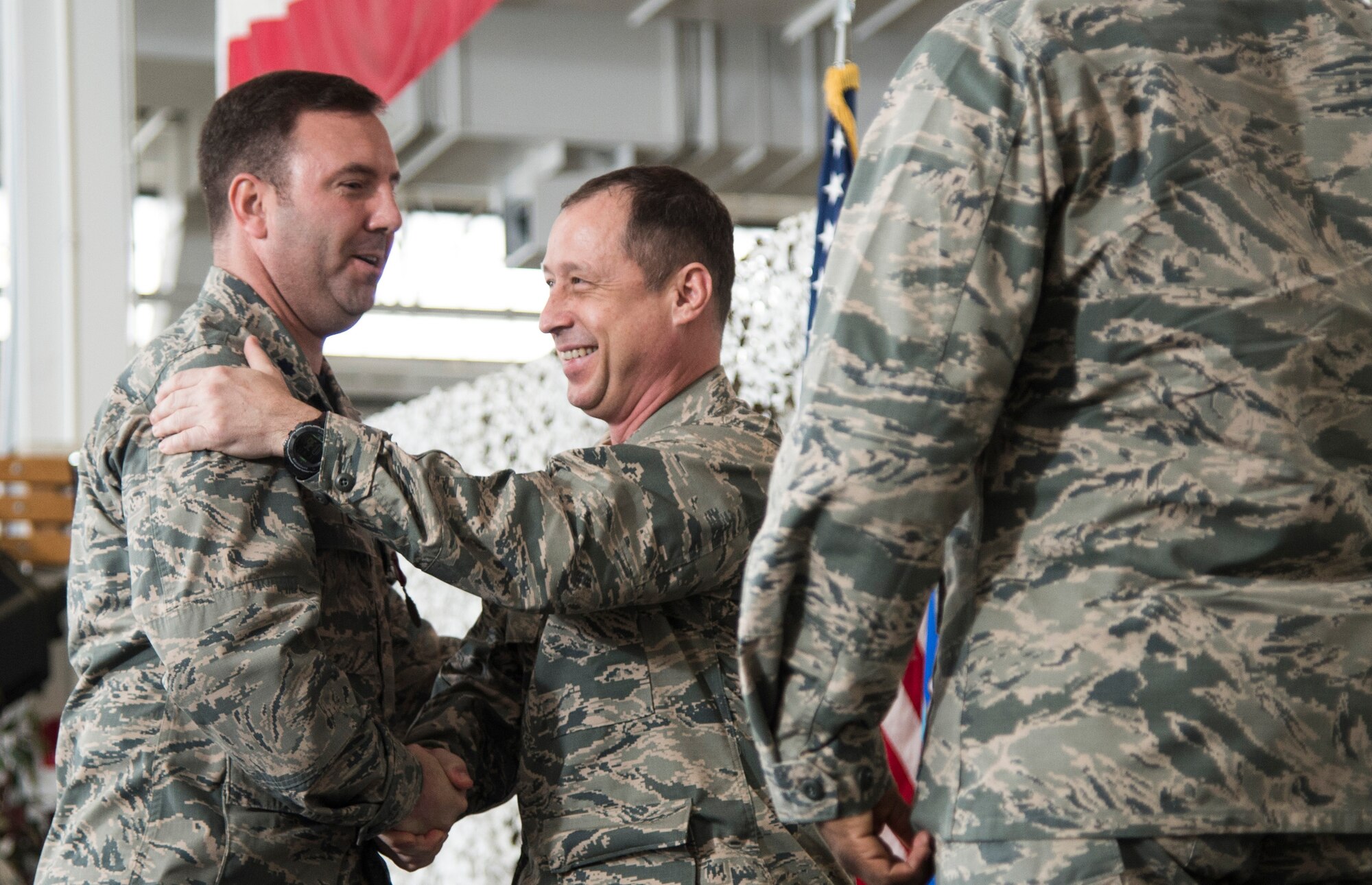 Lt. Col. Justin Niederer is congratulated by Col. Michael Frymire, 817th Contingency Response Group commander, during the 817th Global Mobility Squadron change of command ceremony at Joint Base McGuire-Dix-Lakehurst, N.J., April 17, 2015. (U.S. Air Force photo/Staff Sgt. Gustavo Gonzalez)