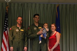 Lt. Col. Patrick Farrell, 16th Airlift Squadron commander (left) presented a Medal of Application to Ethan George, one of the squadron’s Little Lions during the Little Lions ceremony April 10 2015 in the squadron’s auditorium at Joint Base Charleston, S.C. Ethan’s parents are Capt. Brian George, 16th AS and Brooke George.   In all, 35 Little Lions were recognized, and no achievement was too small; everything from helping around the house to making the high school honor list was celebrated.  Each child was given a medal and certificate to thank them for their bravery. (Courtesy photo)

