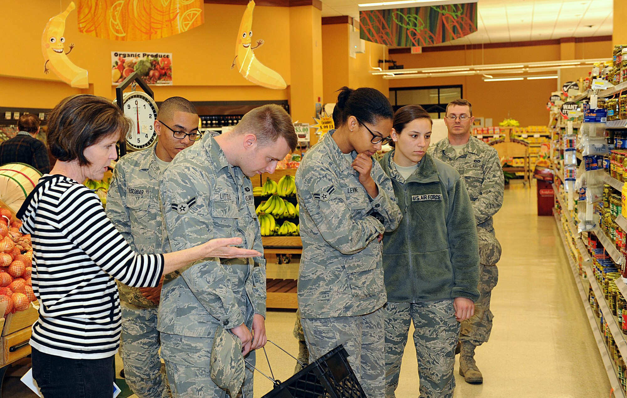 Maribeth Havran, left, 22nd Medical Group health promotion dietitian, shows Airmen some of the healthy products the commissary offers, April 15, 2015, at McConnell Air Force Base, Kan. The 22nd Force Support Squadron Airmen and Family Readiness Center sponsored the first Teach an Airman to Cook class to help Airmen with budget and cooking basics. (U.S. Air Force photo by Senior Airman David Bernal Del Agua)