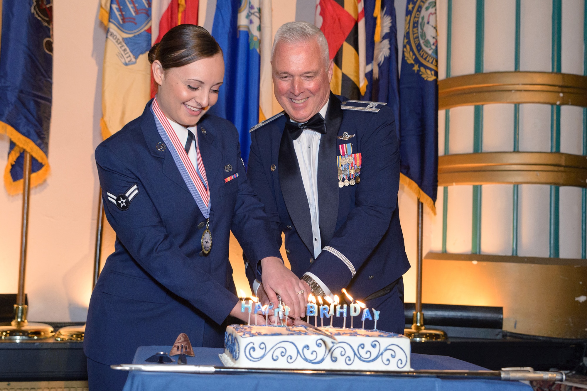 Airman 1st Class Abby Elliot, 446th Aircraft Maintenance Squadron, assists Col. Scott McLaughlin, 446th Airlift Wing commander, in cutting the cake at the 2015 446th Airlift Wing Awards Banquet April 11 at the Landmark Convention Center, Tacoma. (Courtesy photo by David Lobban Photography)
