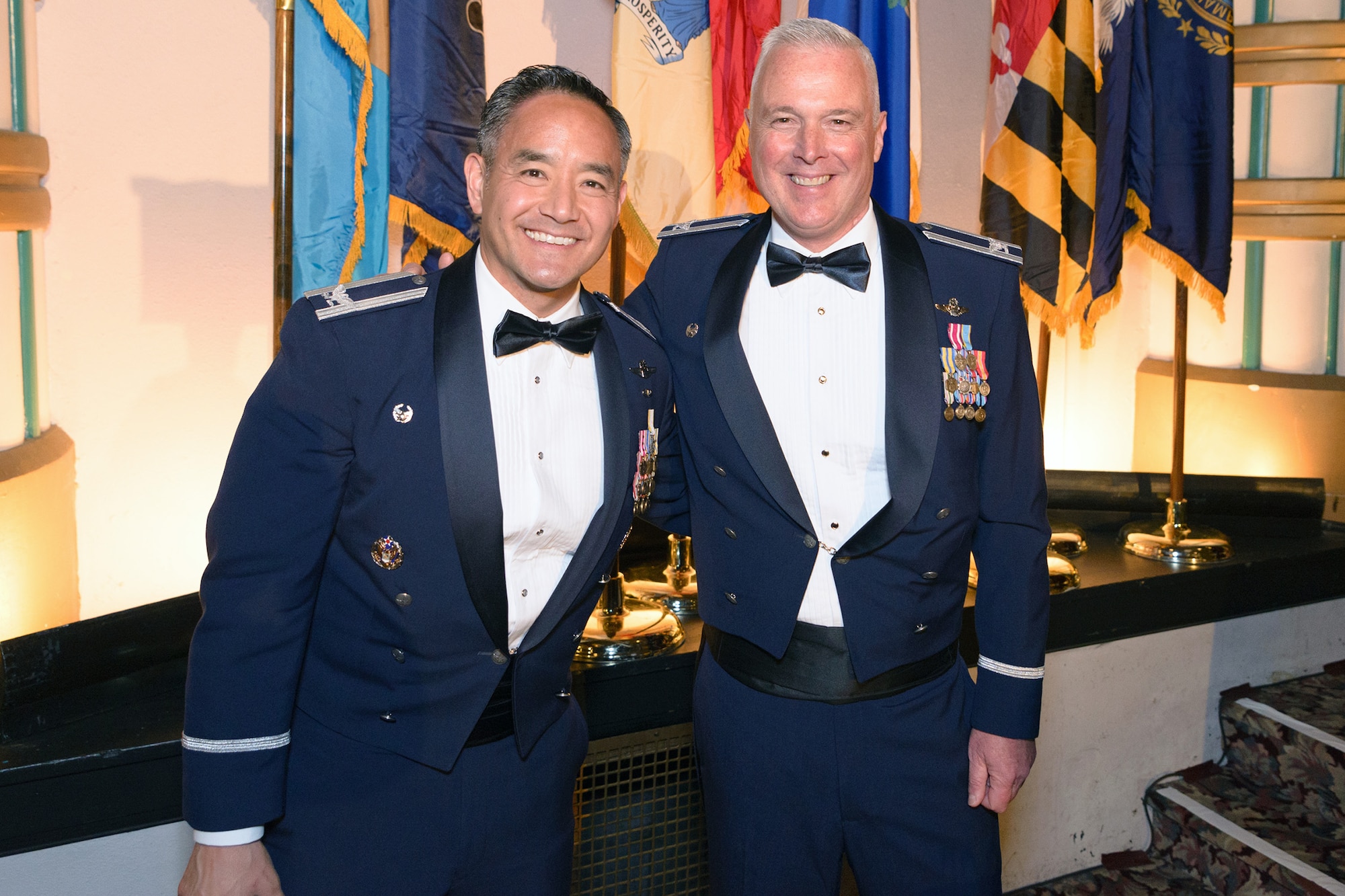Col. David Kumashiro (left), 62nd Airlift Wing commander, and Col. Scott McLaughlin, 446th Airlift Wing commander, epitomize the working relationship between their respective units before the dinner portion of the 2015 446th Airlift Wing Awards Banquet at the Landmark Convention Center, Tacoma, April 11. The event was to honor the wing's quarterly and annual award recipients from 2014. (Courtesy photo by David Lobban Photography)