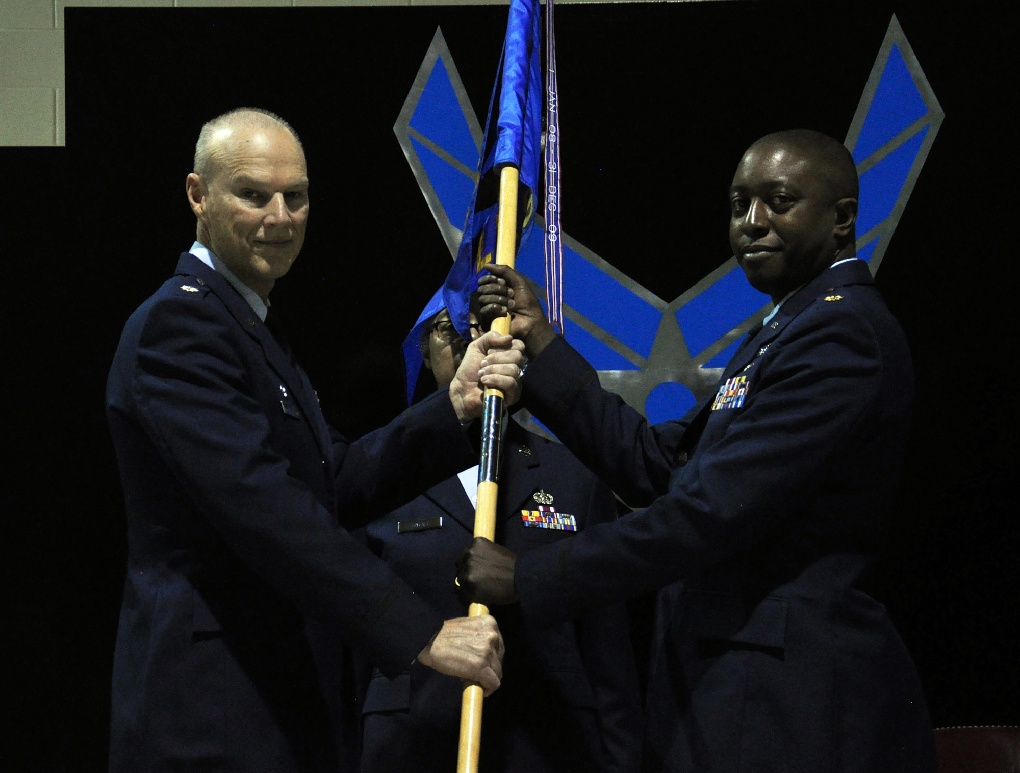 WRIGHT-PATTERSON AIR FORCE BASE, Ohio – Lt. Col. Dale Bateman, 445th Mission Support Group commander, passes the guidon to Maj. Albert Olagbemiro, incoming 445th Logistics Readiness Squadron commander, during the 445th LRS Change of Command ceremony March 8, 2015. (Courtesy photo)