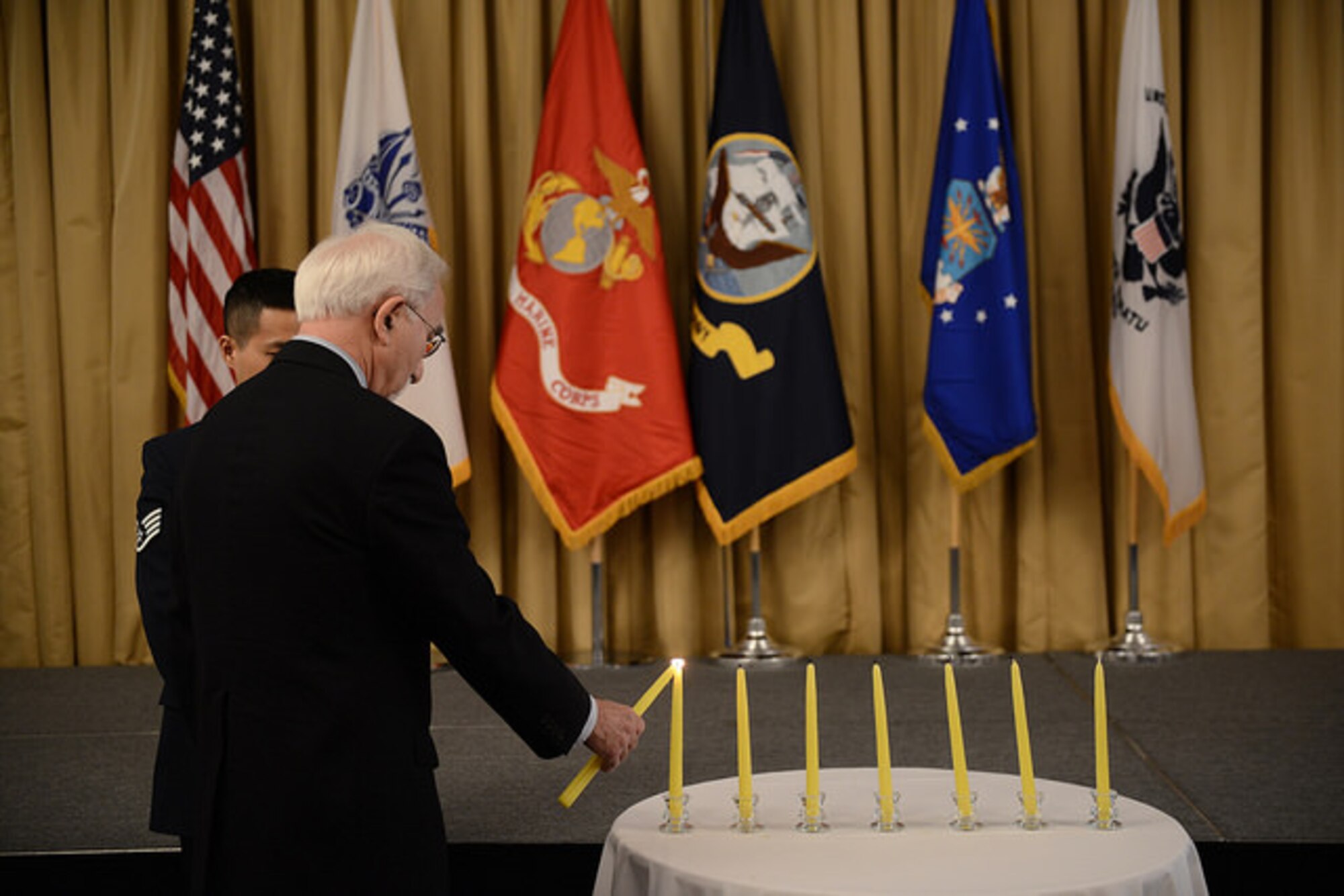 Dr. Charles Rojer, Holocaust survivor and Days of Remembrance guest speaker, lights a candle during the annual event on Joint Base McGuire-Dix-Lakehurst, N.J. April 16, 2015. This year marks the 70th anniversary since concentration camps were liberated by allied forces. (U.S. Air Force photo by Airman 1st Class Joshua King)