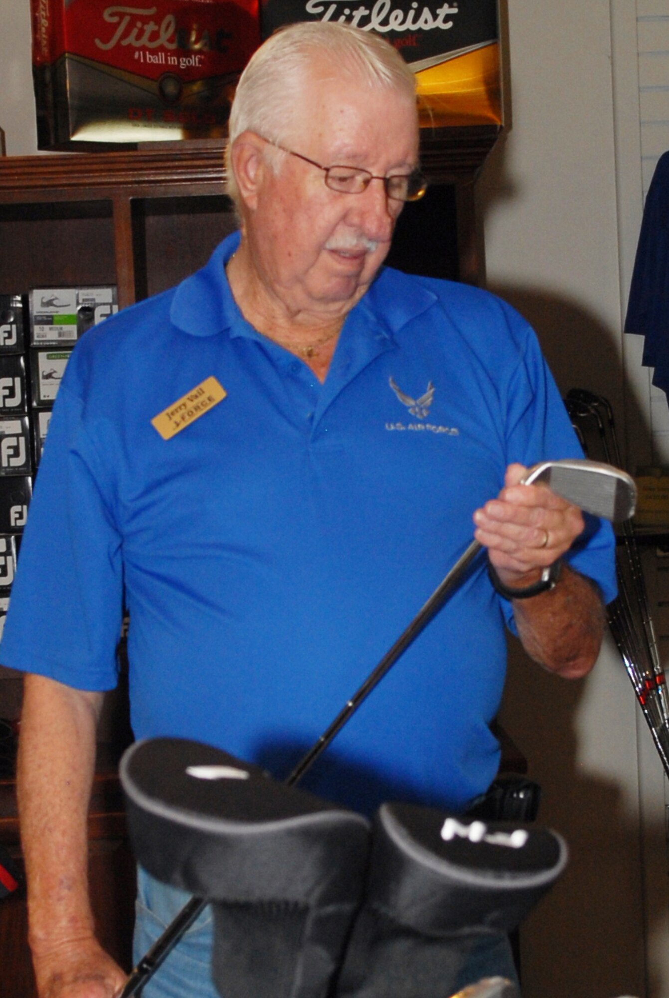 Jerry Vail, Pine Oaks Golf Course pro shop clerk, checks his merchandise. The Pro Shop is open Monday through Sunday from 7 a.m. to 7 p.m. (U.S. Air Force photo by Misuzu Allen)