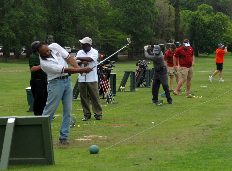 Golfers practice their shots at the Pine Oaks Golf Course driving range, April 13, 2015.(U.S. Air Force photo by Misuzu Allen)
