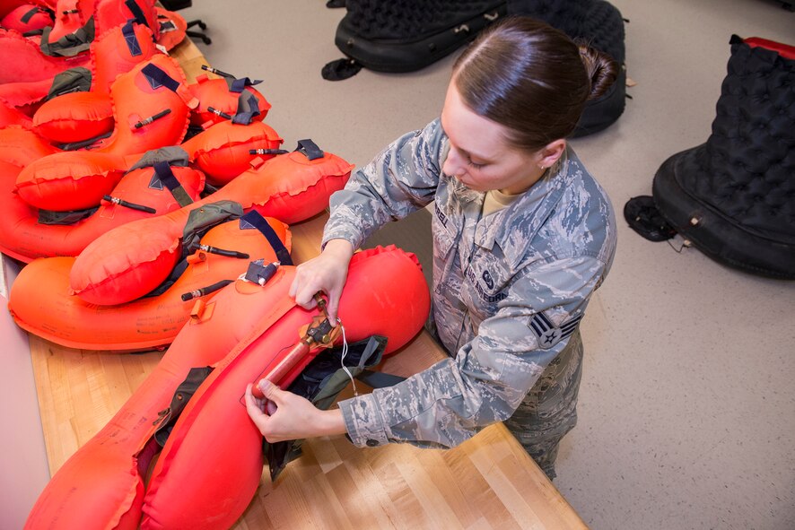 U.S. Air Force Senior Airman Jessica Burrell, 347th Operations Support Squadron aircrew flight equipment technician, untwists a ‘dummy’ carbon dioxide cartridge after a six hour leakage test April 15, 2015, at Moody Air Force Base, Ga. Proper pounds per square inch has to be over 1.5 for proper floatation device standards of the LPU-10/P life preserver. (U.S. Air Force photo by Airman Greg Nash/Released)
