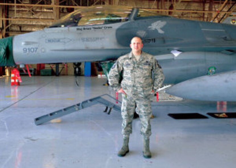 Chief Master Sgt. Ben Carson, 308th Aircraft Maintenance Unit superintendent, stands in front of an F-16 fighter jet March 31 at Luke Air Force Base. Carson began his career as an Airman in the 308th and was in formation on the day of its activation. He will now stand in formation as the squadron’s chief master sergeant as the 308th AMU deactivates in June.
