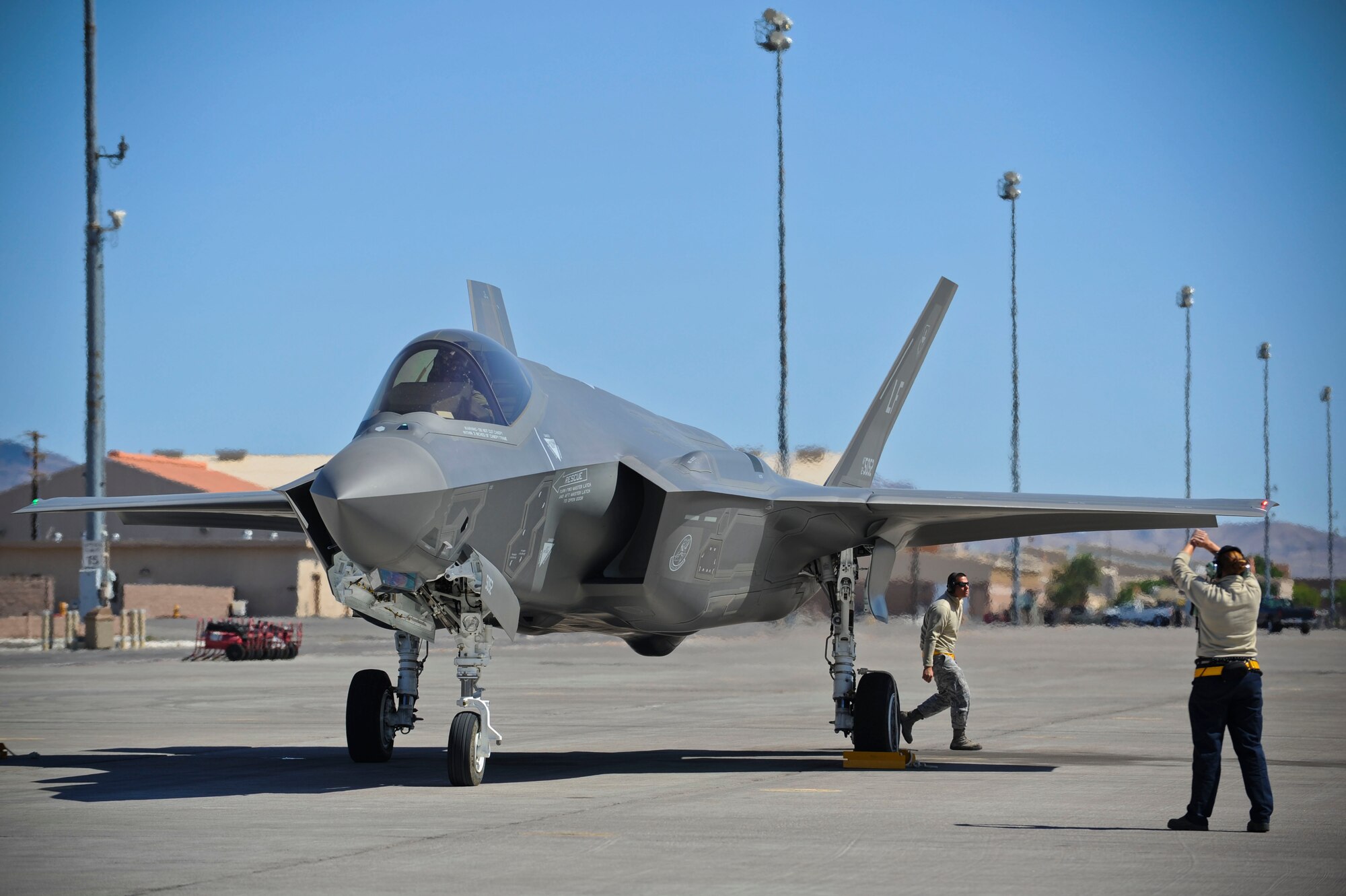 Staff Sgts. David Cruson and Leah Curtin, 61st Aircraft Maintenance Unit Staff F-35 dedicated crew chiefs, prepare a Lightning II for takeoff at Nellis Air Force Base, Nevada, April 15, 2015. (U.S. Air Force photo by Staff Sgt. Darlene Seltmann)
