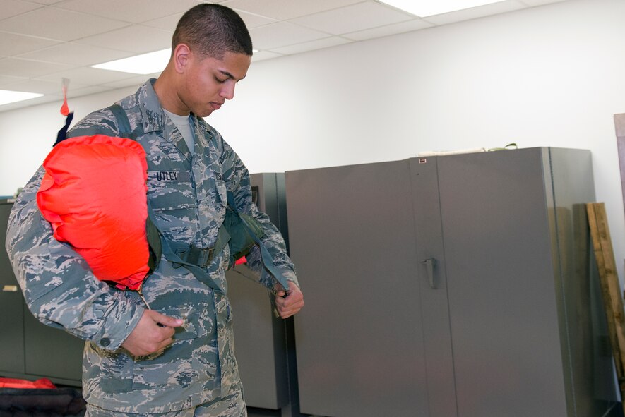 U.S. Air Force Airman 1st Class Ryan Utley, 347th Operations Support Squadron aircrew flight equipment technician, pulls an actuating lanyard for an LPU-10/P life preserver April 15, 2015, at Moody Air Force Base, Ga. Utley demonstrates how the floatation device is used by Team Moody’s HC-130J Combat King II and HH-60 Pave Hawk aircrew members when the lanyard is pulled to inflate the life preserver within seconds. (U.S. Air Force photo by Airman Greg Nash/Released)